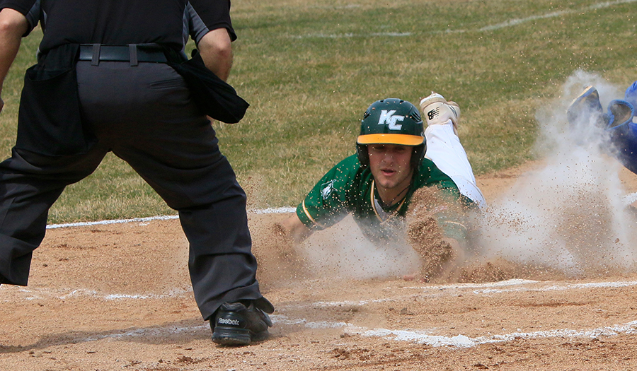 Keuka College men's baseball player sliding into home base